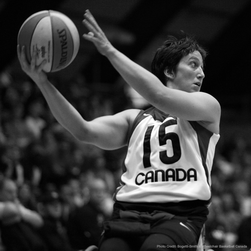 Danielle Peers, featured image, seen preparing to pass a basketball. Wearing a Team Canada jersey