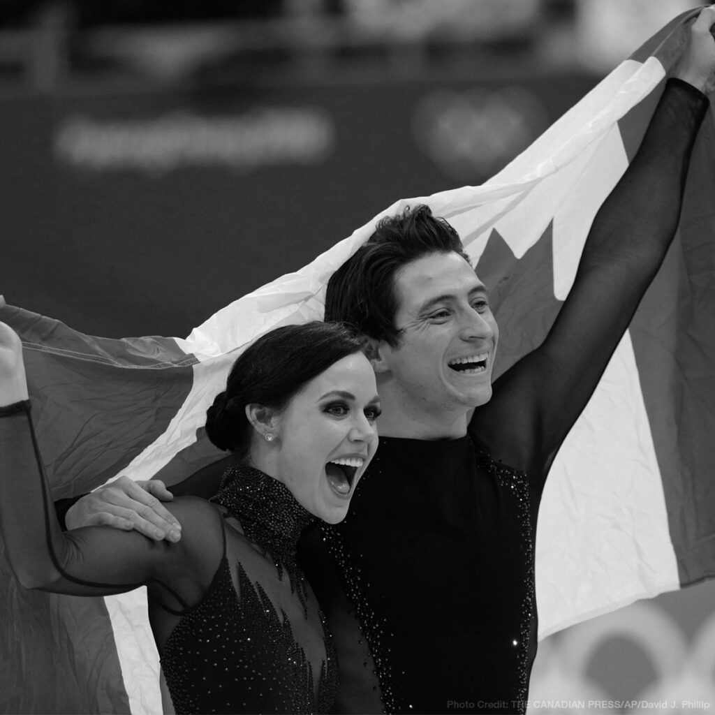Tessa Virtue and Scott Moir, featured image, holding up the Canadian flag together