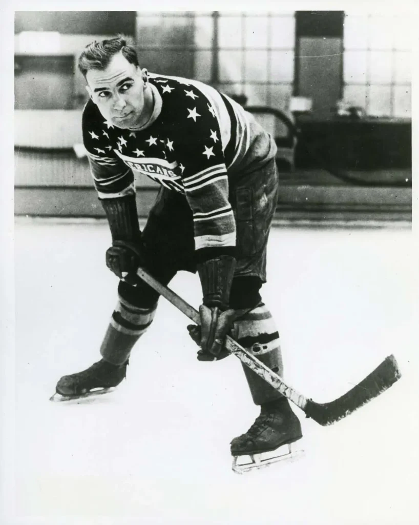 Lionel Conacher in hockey gear and on the ice.