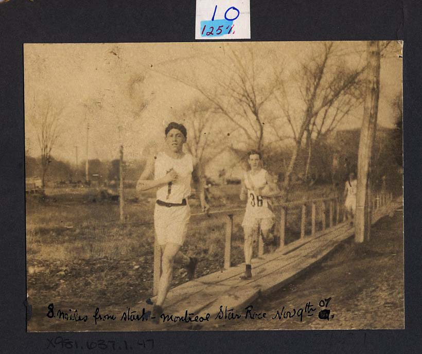 Tom Longboat ahead of Jack Tait in The Montreal Star Race. The photo reads, "8 miles from start - Montreal Star Race - Nov 9th, 1907."