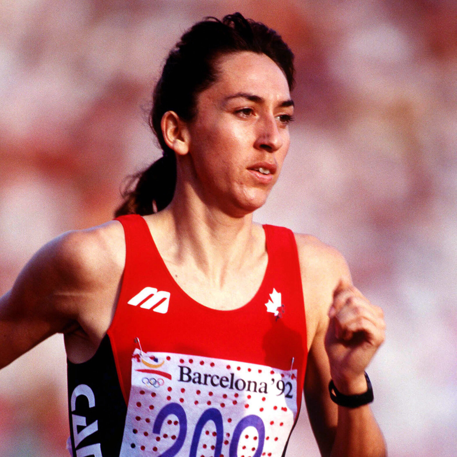 Angela Chalmers running in her Team Canada athletics jersey