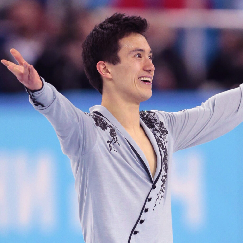 Patrick Chan during a performance with his arms open addressing the crowd